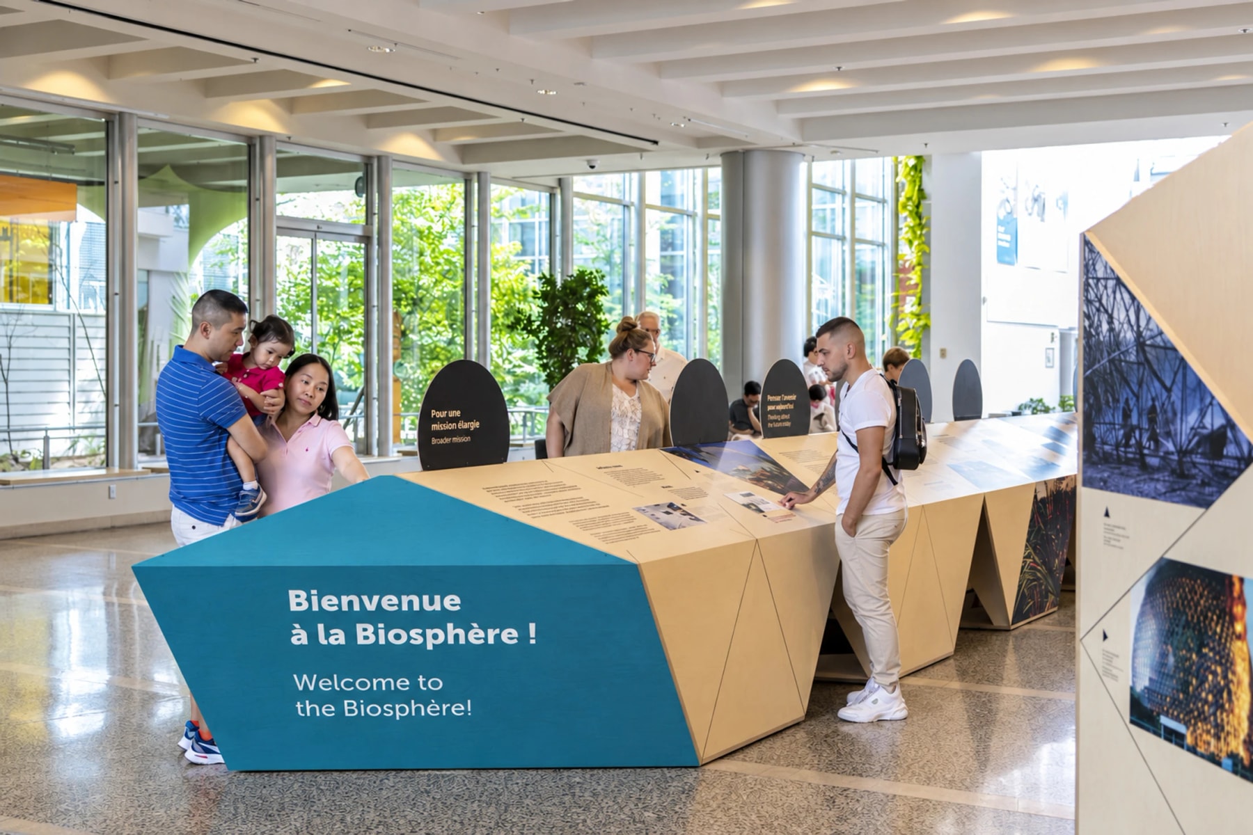 Visitors gather around an exhibition table at the Biosphère.