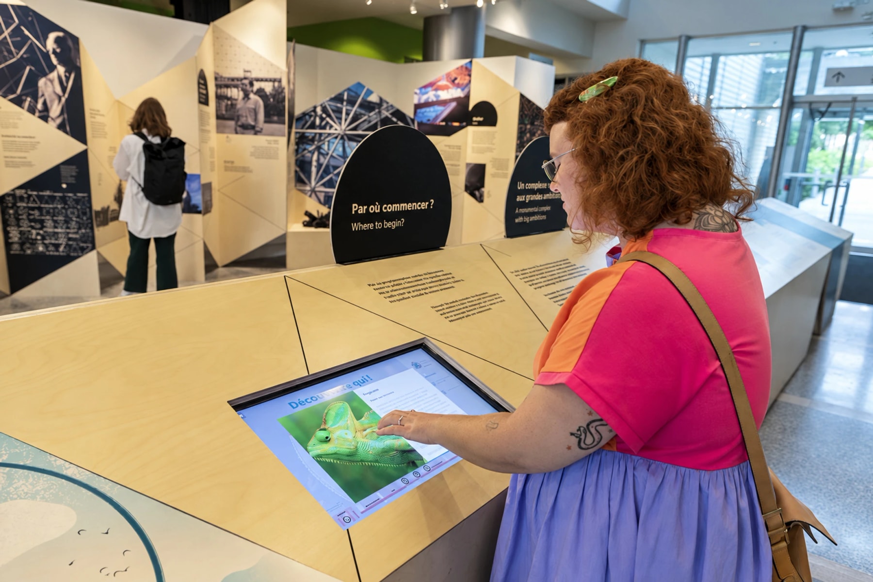 A visitor uses a touchscreen in a Biosphère exhibition.