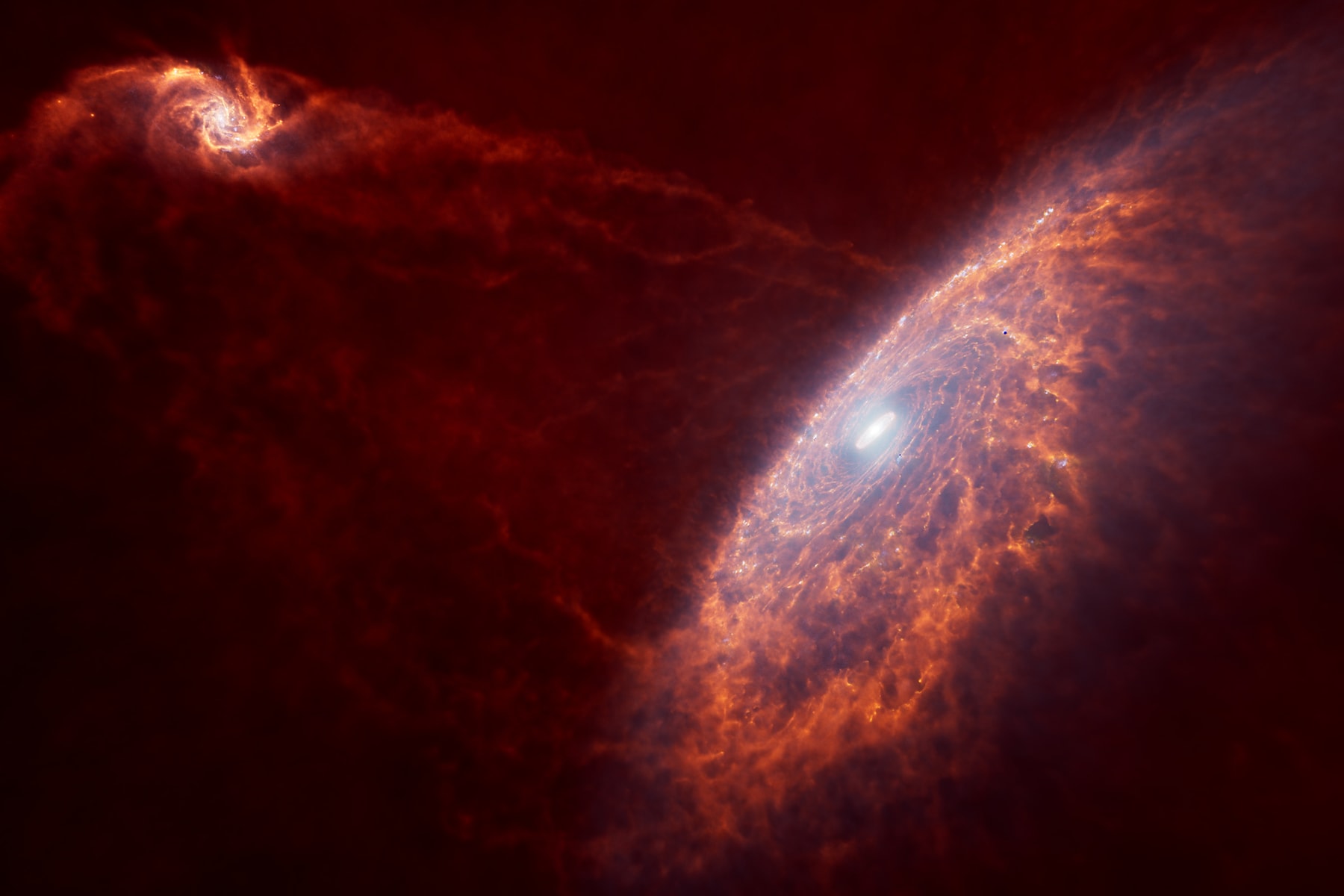 Illustration de deux galaxies spirales rougeoyantes reliées par des filaments de gaz.
