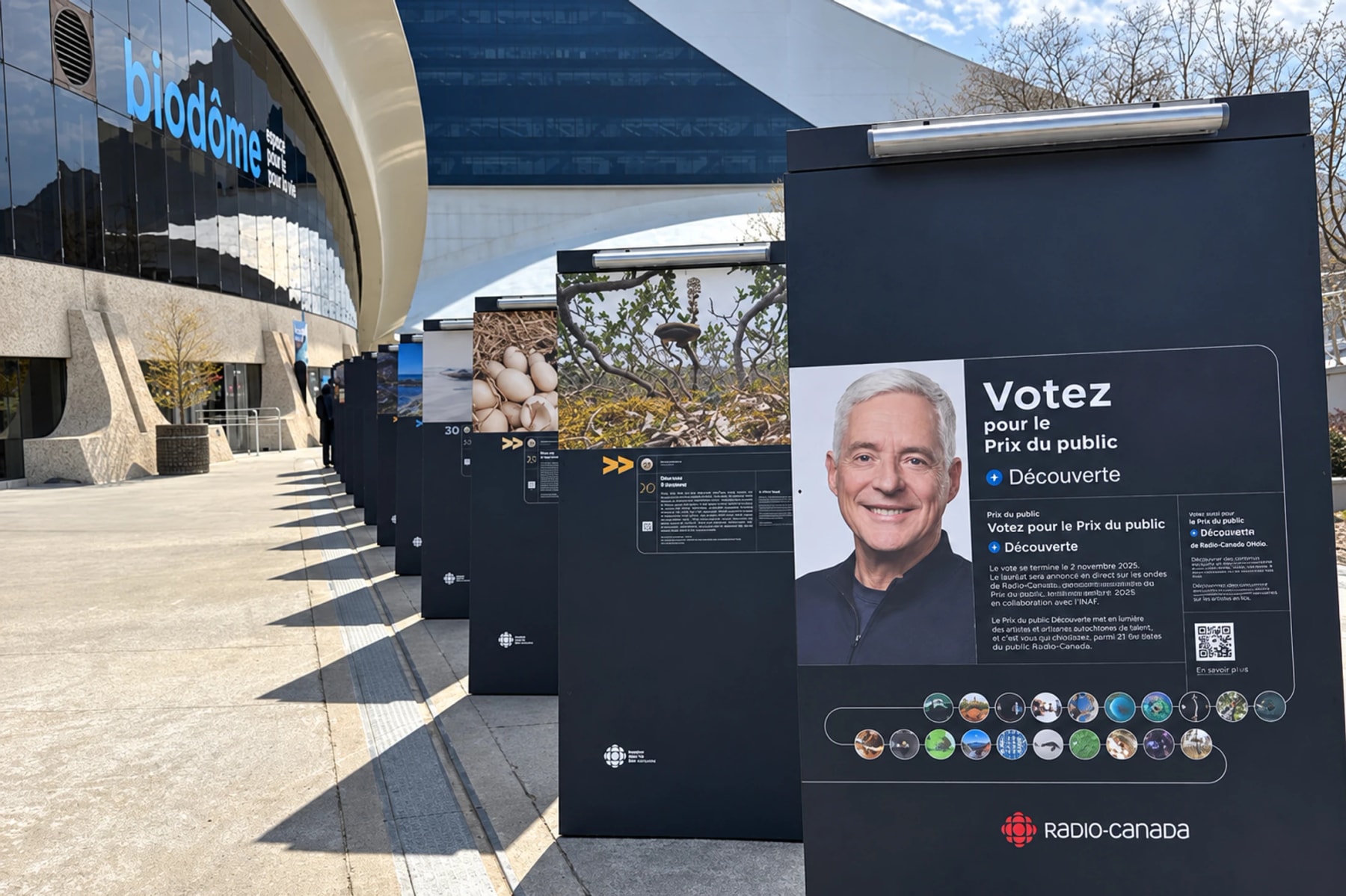 Outdoor science exhibition panels line the walkway beside the Biodôme.